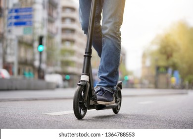 Businessman On Daily Commute Riding Micro Scooter