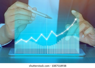 Businessman on digital stock market financial positive indicator background. Double exposure of growth graph futuristic economic currency chart investor data analysis technology money exchange concept