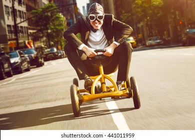 Businessman on a pedal car