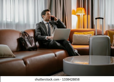 Businessman On The Phone At A Hotel Room. Executive Manager Talking On The Phone.