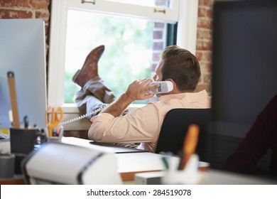 Businessman On Phone Relaxing In Modern Creative Office