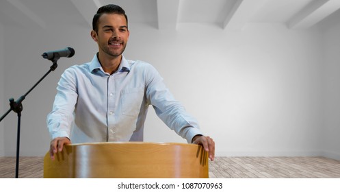 Businessman On Podium Speaking At Conference In Room