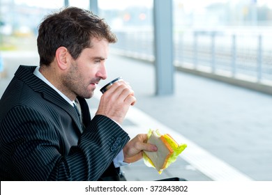 businessman on trip sitting on a bench and has a break
