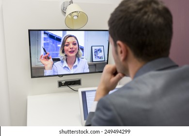 Businessman on video conference with her colleague in office job - Shutterstock ID 249494299