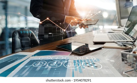 Businessman online using mobile banking payment with financial application icons. Financial innovation technology develop smart e commerce service and growth digital transaction. Digital marketing. - Shutterstock ID 1954078291