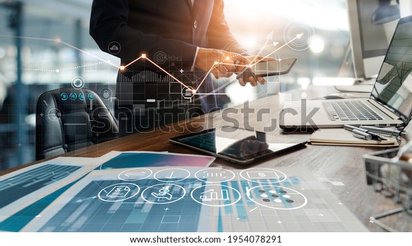 Businessman online using mobile banking\
payment with financial application icons. Financial innovation\
technology develop smart e commerce service and growth digital\
transaction. Digital\
marketing.