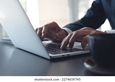 Businessman online working on laptop computer, surfing the internet, networking at modern office, closeup. Business man hand typing ob laptop computer keyboard on office desk - Shutterstock ID 2274659745