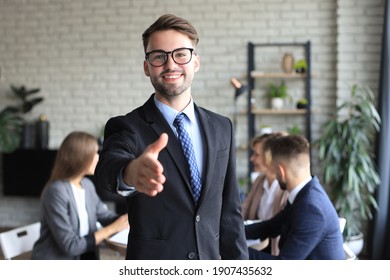 Businessman with an open hand ready to seal a deal - Powered by Shutterstock