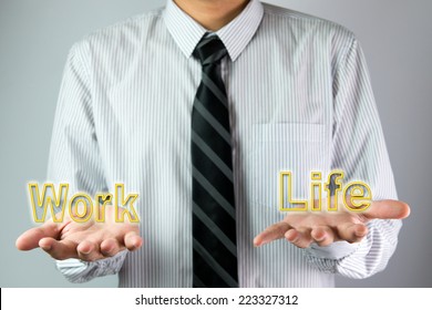 Businessman with open hands palm balancing the word work and life