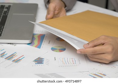 Businessman Opening Business Report Document In Letter Envelope - Business Concept