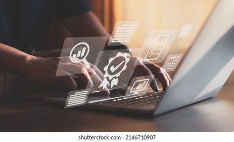 Businessman operating with the quality assurance, guarantee, standards, ISO certification, and standardization notion as a proof of top service. - Shutterstock ID 2146710907