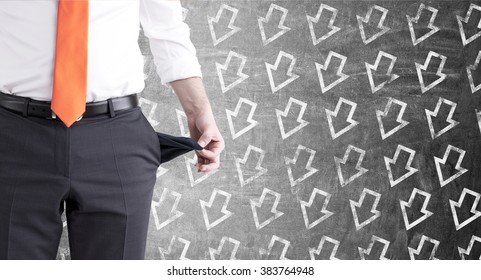 A Businessman With An Orange Tie Turning His Empty Pockets Inside Out. Front View, No Head. Arrows Down On The Black Background. Concept Of Bankruptcy.