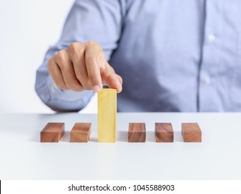 Businessman And Outstanding Wooden Toy Block, Different Concept