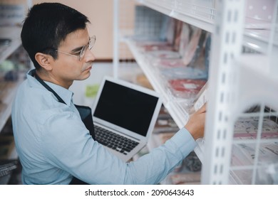 Businessman Owner Staff Using Computer Laptop Checking Product Inventory Shelf In Grocery Store