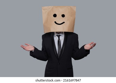 Businessman and paper bag her head  Excellent great smile happy face emotion mood icon   open palm hands gray banner background