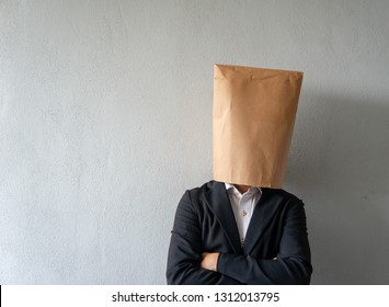 A Businessman With Paper Bag On His Head.