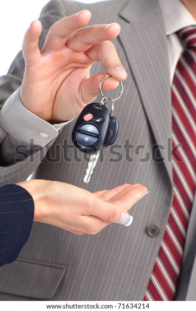 A businessman passing a car\
key