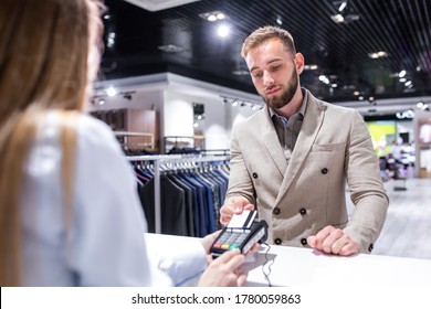 Businessman Paying By Credit Card In A Clothing Store.