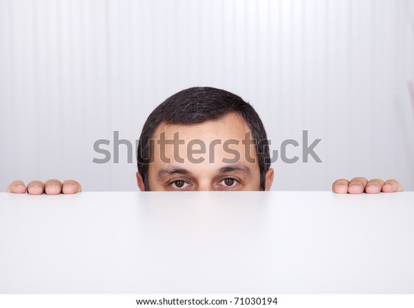 Businessman Peeking Behind Desk Looking Camera Stock Photo 71030194 ...