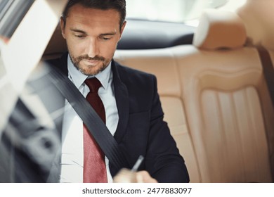 Businessman, person and travel in car with writing for schedule, calendar and agenda in morning commute. Professional, employee and backseat of taxi, cab or chauffeur with trip to airport or meeting - Powered by Shutterstock