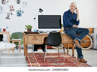 Businessman, phone call and relax on desk, office and portrait for creative manager. Smile, computer and graphic designer for magazine, male person and communication on cellphone for conversation - Powered by Shutterstock