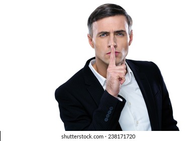 Businessman Placing Finger On Lips Saying Shhh, Be Quiet!