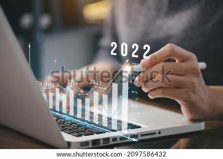 Businessman plan business growth and financial, increase of positive indicators in the year 2022 to increase business growth and an increase for growing up business 