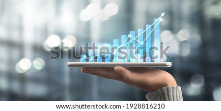 Businessman plan graph growth and increase of chart positive indicators in his business,tablet in hand