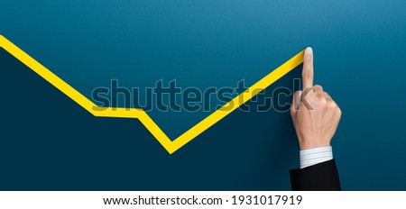 Businessman plan the growth and development, Economic recovery, businessman hand drawn a yellow line up