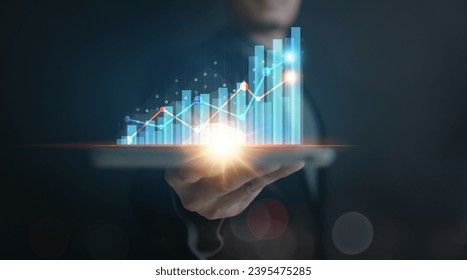 businessman planing and using holographic in the office workplace for work progress about investment and money management with trading chart  financial plan to making and calculate passive incomes  - Shutterstock ID 2395475285