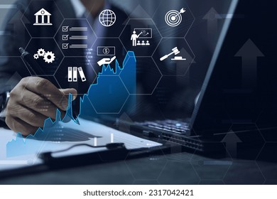 Businessman is planning a business by studying market analysis, international law, trade law, international banking or trade covenant. through the computer screen. Business model infographic concept - Powered by Shutterstock