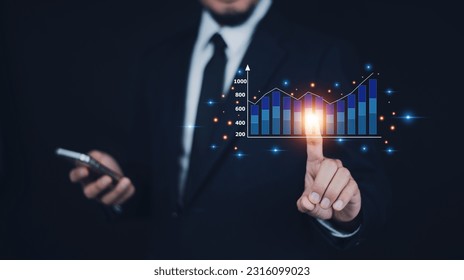 Businessman planning and strategy, Stock market, Business growth, progress or success concept. Businessman or trader is showing a growing virtual hologram stock, invest in trading. - Shutterstock ID 2316099023