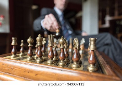 Businessman playing chess, strategy concept