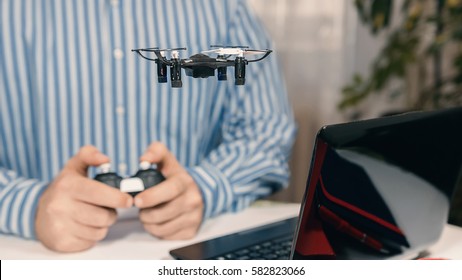 Businessman Playing With Drone Toy To Relieve Stress At Work. Businessman Testing New Toy On Desk In Office. Office Playing.