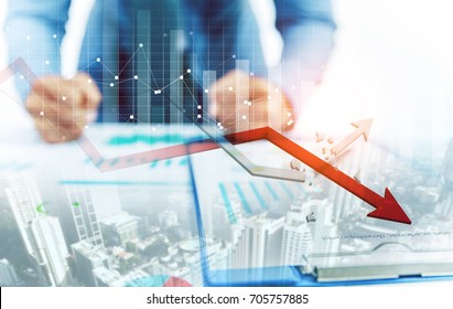 Businessman point at decreasing graph and increasing broken graph with city background