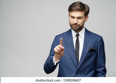 Businessman point finger at invisible screen, hand pushing touch screen, business man pressing digital virtual button isolated over grey background - Powered by Shutterstock