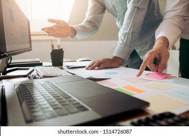 Businessman point to the graph of the company financial statements in the paperwork and together analyzing the work room.