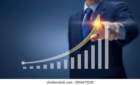 Businessman Point Hand On Arrow Graph With High Rate Of Growth Show Financial, Sale Profit, Business Plan, Stock Market Investment, Economic Growth Concept. Business Man Draw Report Chart Up Forward 