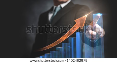 Businessman pointing arrow graph and chart, corporate growth plan or business development to success and growing growth concept