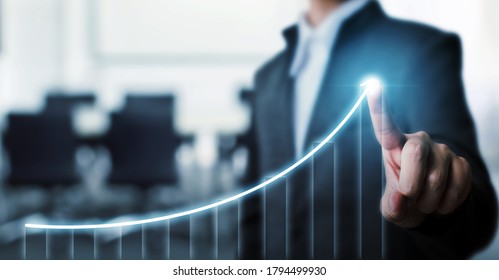 Businessman pointing arrow graph corporate future growth plan with blurred background office. Business development to success and growing growth concept. - Shutterstock ID 1794499930