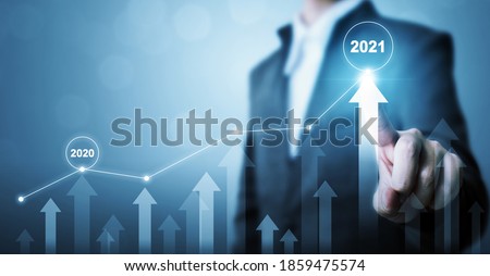 Businessman pointing arrow graph corporate future growth plan. Business development to success and growing growth year 2020 to 2021 concept