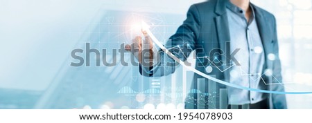 Businessman pointing arrow graph growth and financial network connection, analysing data to increase sales and revenue profit to achieve business investment goal in global economic situation. Imagine de stoc © 