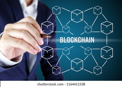 Businessman pointing at blockchain concept.Blockchain technology concept with cube and line connected.
