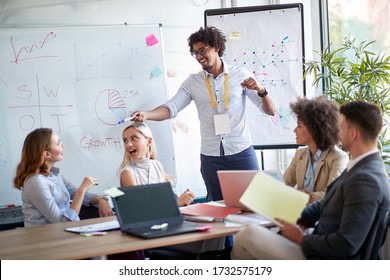 Businessman Pointing At A Coworker In A Pitch Meeting.  Coworkers Discussing In A Meeting. Great Team Work Example.