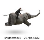 Businessman with pointing finger gesture riding on elephant, isolated on white.