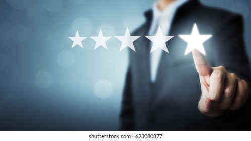 Businessman pointing five star symbol to increase rating of company - Shutterstock ID 623080877