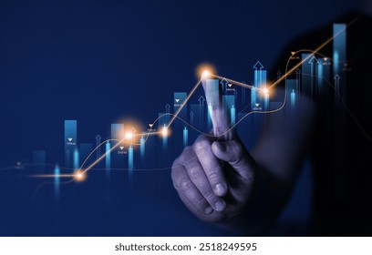 Businessman pointing growing virtual hologram of statistics, graph and chart.Business strategy development and growing growth plan. Investment of growth on currency rate.