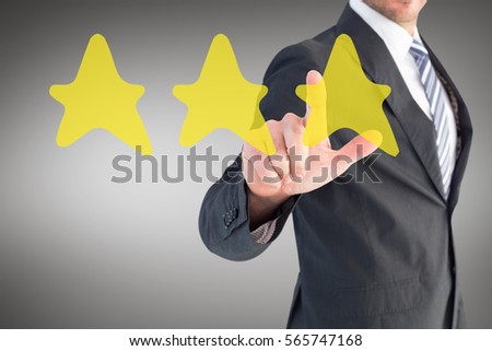 Businessman pointing with his finger against grey vignette