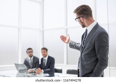 Businessman Pointing To His Office