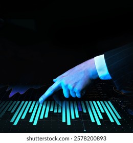 Businessman pointing at illuminated bar graphs on futuristic digital interface featuring financial analytics, data visualization, and trends. Concept of business, technologies, data, engineering. Ad